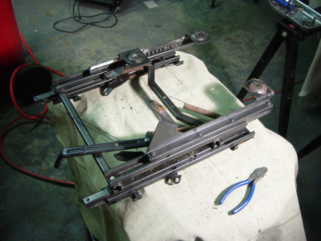 More careful measuring, cutting, and filing will get the forward leg in the right place, too.  There's not enough room in the truck floorpan for the leg to sit on the downward slope, so it had to be moved back several inches to rest flat on the floorpan.