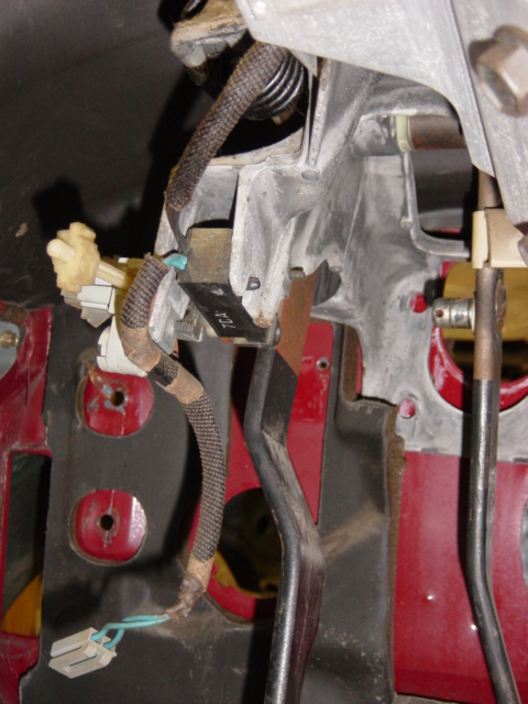 1991 Ford Bronco - Close-up view of the interior pedal assembly, showing various mechanical and electrical components.