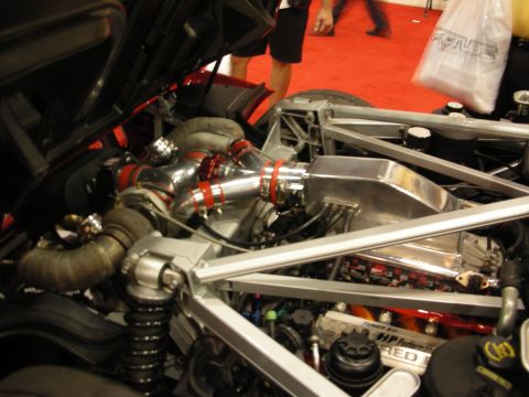 1998 Ford Crown Victoria - tube-frame chassis engine bay packed with polished turbo piping, coilover shocks and red intake couplers.