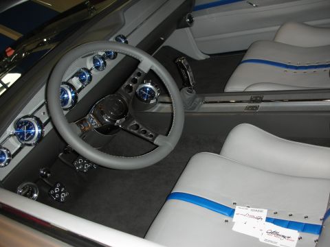 1998 Ford Crown Victoria - Custom interior with a gray three-spoke steering wheel, blue-faced gauges and white seats with blue stripe accents.