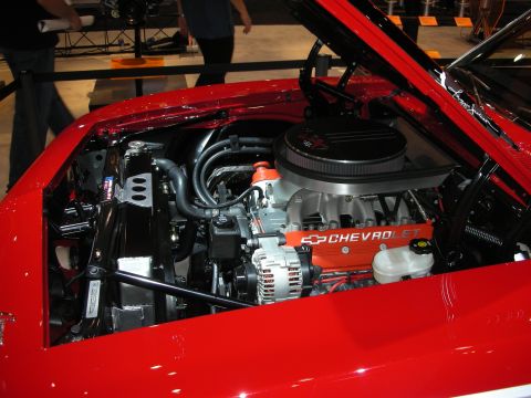 1998 Ford Crown Victoria - Chevrolet V8 with red CHEVROLET valve covers and a chrome air cleaner sits in the engine bay of a red show car.