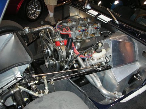 1998 Ford Crown Victoria - polished V8 engine topped with multiple individual carburetor stacks, mounted in a bare aluminum and tube chassis.