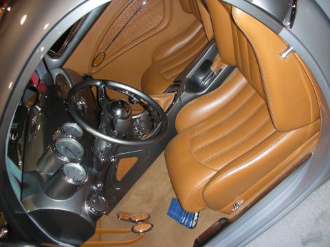 1998 Ford Crown Victoria - Custom car interior featuring tan leather bucket seats, body-color dash, and a dark three-spoke steering wheel.