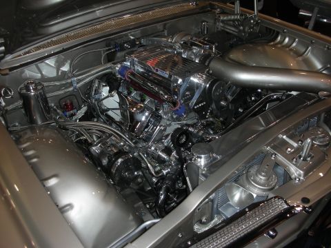 1998 Ford Crown Victoria - highly polished supercharged V8 engine with chrome accents fills the engine bay of a silver custom show car.