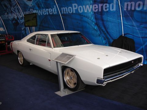 1998 Ford Crown Victoria - white two-door muscle car coupe with gold wheels sits on a display stand in front of a blue moPowered backdrop.