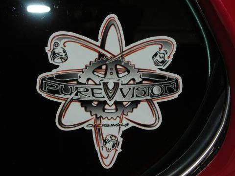 1998 Ford Crown Victoria - Pure Vision Originals decal with an atomic gear-and-piston emblem applied to a glossy black car body panel.