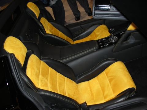 1998 Ford Crown Victoria - Custom sport bucket seats trimmed in black leather and yellow suede flank a black center console and shifter.