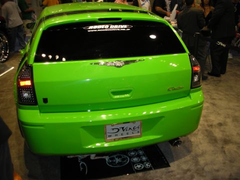 1998 Ford Crown Victoria - Rear view of a bright green Chrysler 300 show car with smoked taillights and a D'Vinci Wheels license plate.