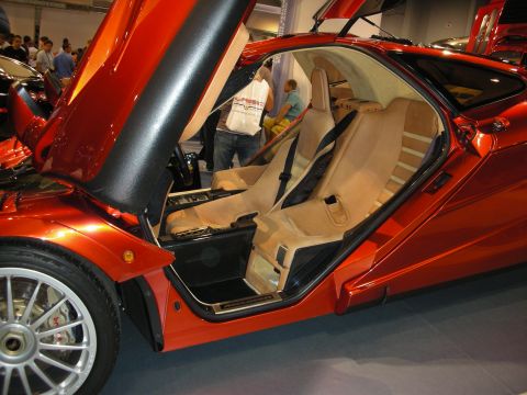 1998 Ford Crown Victoria - Interior view of a striking orange sports car, its tan seats and distinctive butterfly doors.