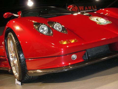 1998 Ford Crown Victoria - A red sports car is displayed with its front end visible, unique headlights and a carbon fiber lower grille.