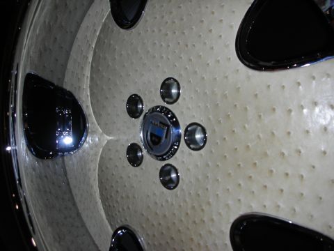 1998 Ford Crown Victoria - Detail of a custom wheel face with cream dimpled spokes, black accents and a polished center cap with chrome lug bolts.