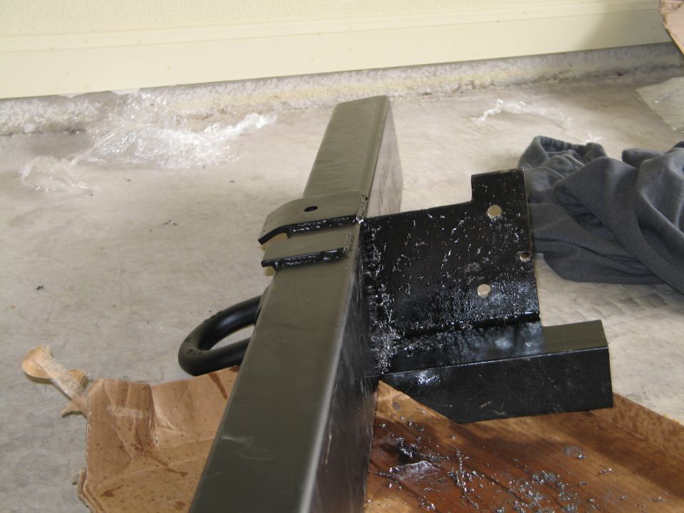 Black rear bumper part with tow hitch and mounting bracket