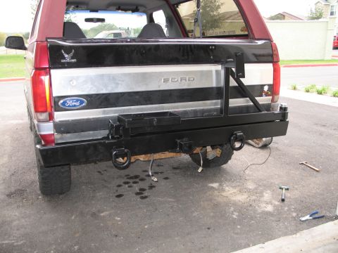 1995 Ford Bronco - The rear of a Ford Bronco shows a custom bumper with a spare tire mount and tow hooks.