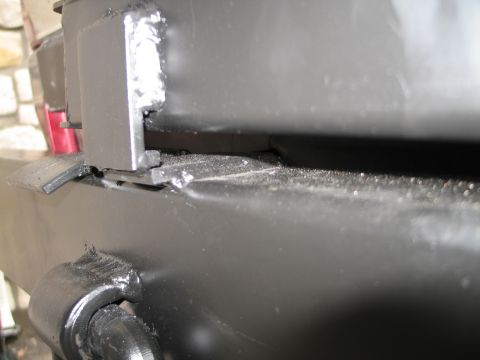 1995 Ford Bronco - Close-up view of a black metal rear bumper, showing welds and a mounting bracket.