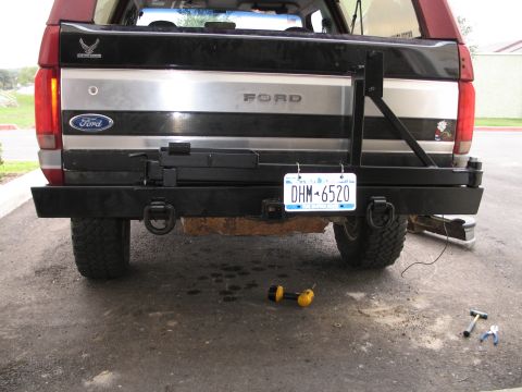1995 Ford Bronco - The rear of a 1995 Ford Bronco features a custom heavy-duty bumper and a spare tire mount.