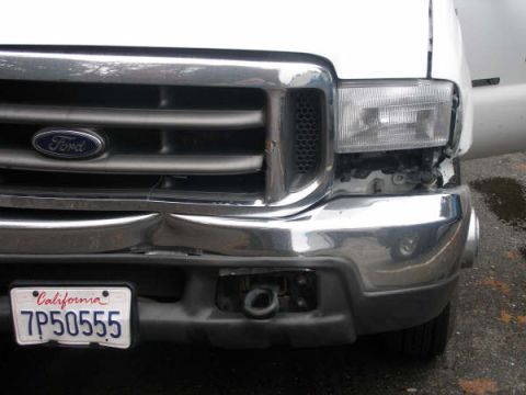 1993 Ford Bronco - This Ford truck shows significant damage to its front bumper and headlight assembly.