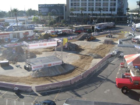 1998 Ford Crown Victoria - An outdoor event setup features a stunt course with various trucks and ramps, sponsored by Toyota and Truck Trend.