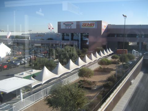 1998 Ford Crown Victoria - Outdoor view of the SEMA building with blimps and tents, suggesting an automotive event.