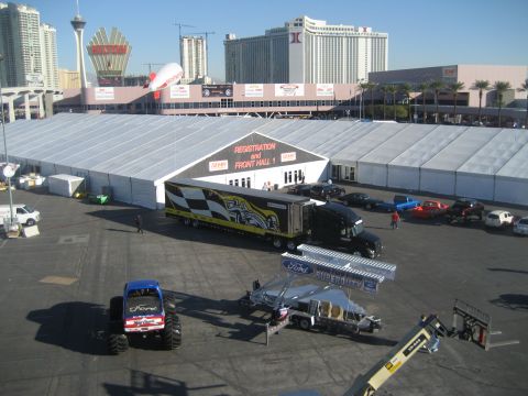 1998 Ford Crown Victoria - An outdoor event scene a large registration tent, a semi-truck, and various other vehicles.
