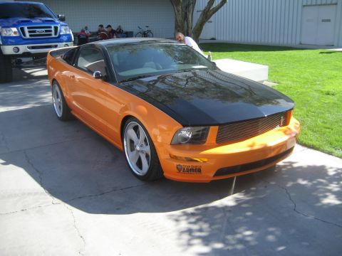 1998 Ford Crown Victoria - This orange and black Ford Mustang features custom wheels and a distinctive two-tone paint scheme.