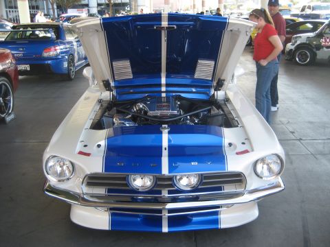 1998 Ford Crown Victoria - A classic Shelby GT500 with its engine exposed, drawing attention from onlookers.