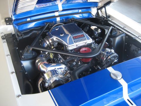 1998 Ford Crown Victoria - Customized engine bay with a prominent Paxton supercharger and striking blue and white racing stripes.