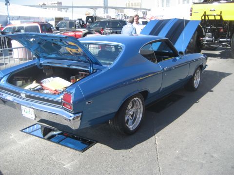 1998 Ford Crown Victoria - A blue 1969 Chevrolet Chevelle SS is displayed with its hood and trunk open, showing off its interior and engine bay.