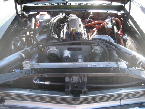 1998 Ford Crown Victoria - Custom engine bay features a prominent supercharger and intricate plumbing, suggesting significant performance modifications.