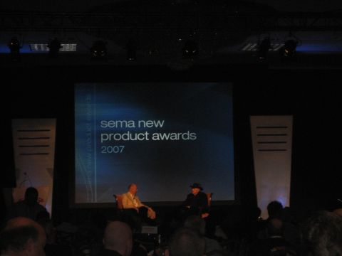 1998 Ford Crown Victoria - The screen behind two men on stage displays "sema new product awards 2007".