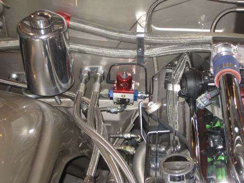 1998 Ford Crown Victoria - Close-up view of custom engine bay components including a chrome reservoir and fuel pressure regulator.