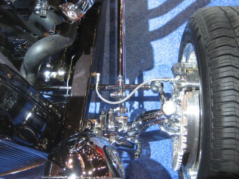 1998 Ford Crown Victoria - Close-up of a highly customized car's front suspension and wheel assembly.