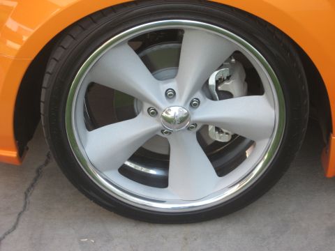 1998 Ford Crown Victoria - Close-up of a custom five-spoke wheel with a chrome lip and silver finish, mounted on an orange vehicle.