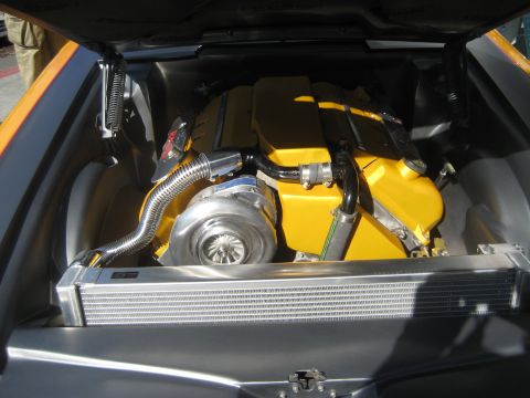 1998 Ford Crown Victoria - Custom engine bay features a bright yellow engine block, a prominent turbocharger, and an aluminum radiator.