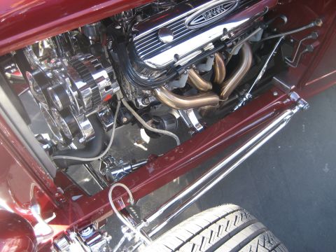 1998 Ford Crown Victoria - Close-up of a custom engine bay with polished chrome components and maroon paint.