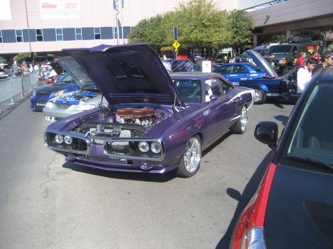 1998 Ford Crown Victoria - Customized purple 1970 Dodge Super Bee on display at an outdoor car show.