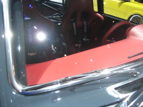 1998 Ford Crown Victoria - Car interior Sparco racing seats and a red dashboard, with another vehicle seen through the windshield.
