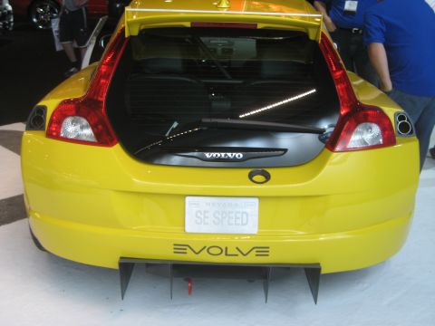 1998 Ford Crown Victoria - Rear view of a yellow Volvo hatchback a custom diffuser and 'EVOLVE' badging on the lower bumper.