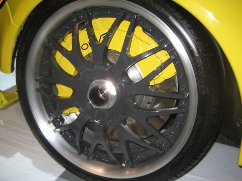 1998 Ford Crown Victoria - This image shows a close-up of a custom wheel and bright yellow brake caliper, not a 1998 Ford Crown Victoria.