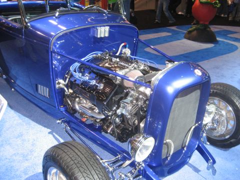 1998 Ford Crown Victoria - Close-up of a custom blue hot rod, its powerful engine and polished exterior.