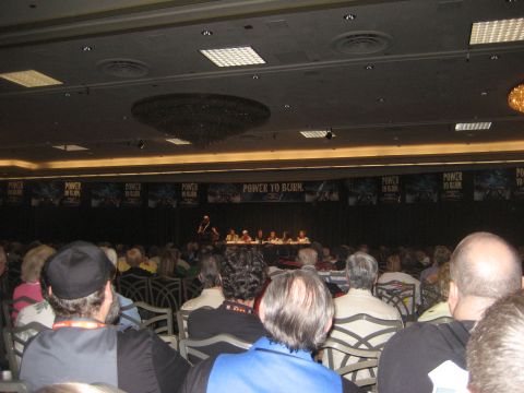 1998 Ford Crown Victoria - A presentation is underway in a conference hall, with banners displaying 'POWER TO BURN.'