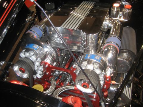 1998 Ford Crown Victoria - This engine bay features polished chrome and vibrant red components, highlighting a powerful twin-turbo setup.