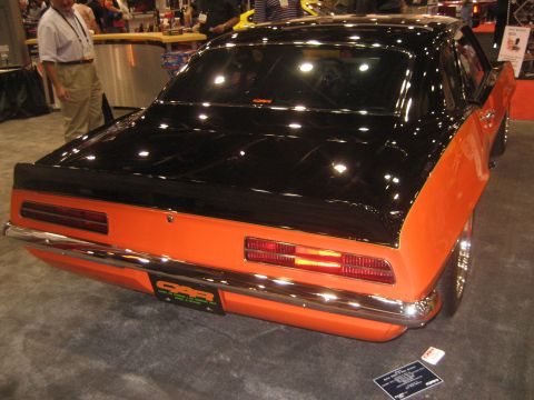 1998 Ford Crown Victoria - This custom classic car features a striking orange and black paint scheme with a prominent chrome bumper and a custom license plate.