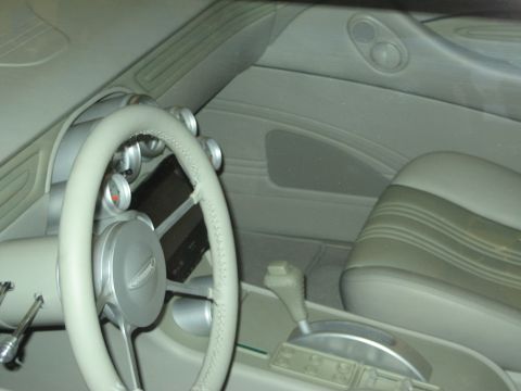 1998 Ford Crown Victoria - The interior of a car shows a steering wheel, dashboard, and seats with a custom look.