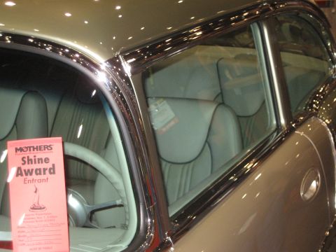 1998 Ford Crown Victoria - A red card indicating "Mothers Shine Award Entrant" is visible on the steering wheel of this classic car's interior.