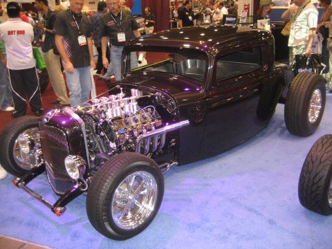 1998 Ford Crown Victoria - Custom hot rod with exposed V8 engine and chrome wheels on display.