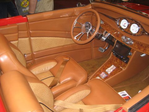 1998 Ford Crown Victoria - The custom interior features tan leather seats with perforated inserts and a wood-grain dashboard with modern gauges.