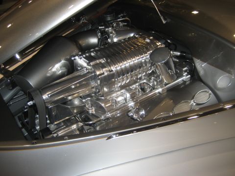 1998 Ford Crown Victoria - The highly polished engine bay features a prominent supercharger and intricate chrome details.