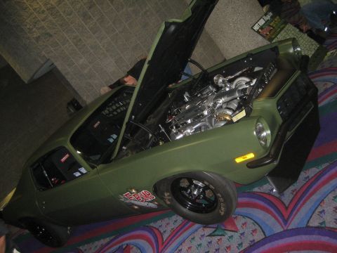 1998 Ford Crown Victoria - This heavily modified car features a custom twin-turbocharged engine under its open hood.