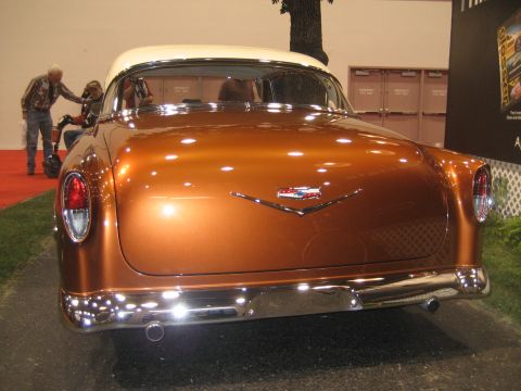 1998 Ford Crown Victoria - A vintage Chevrolet sedan with a distinctive chrome emblem and two-tone paint is displayed indoors.