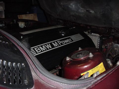 1984 BMW 3 Series - Close-up of a BMW M Power engine cover, part of the engine bay.